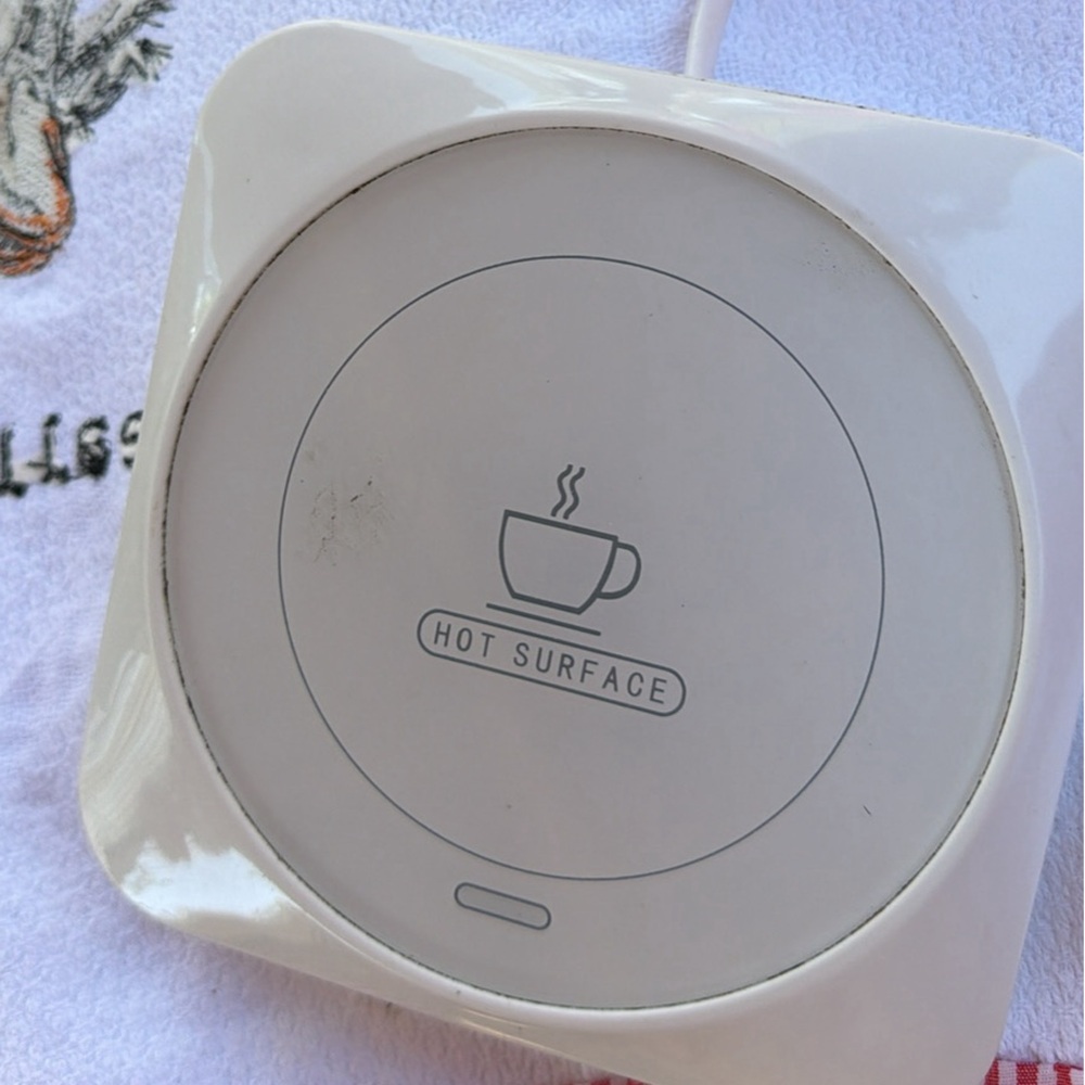 White Electric portable coffee cup warmer for desk